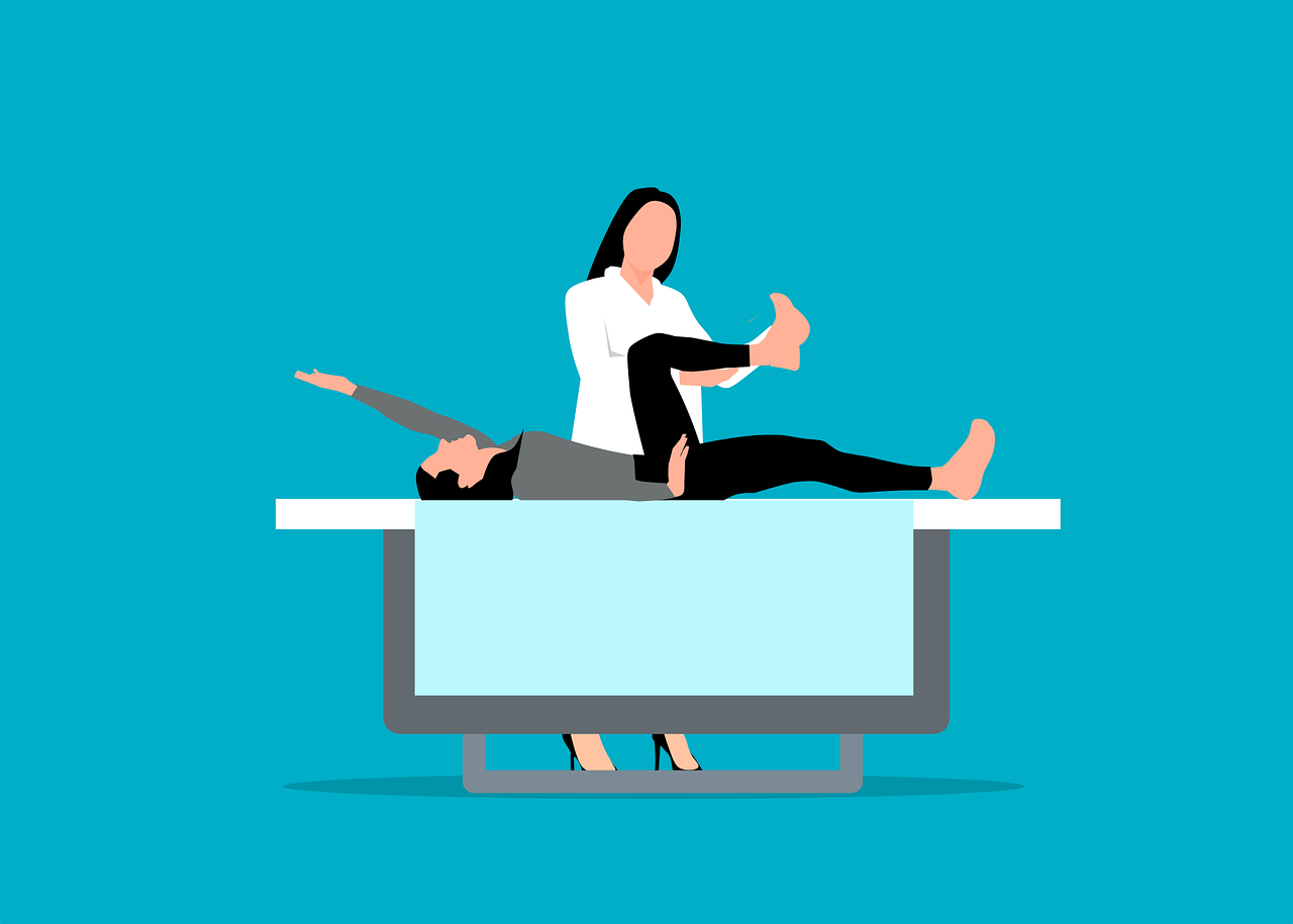 A woman is laying on a table while a man is laying on top of her.